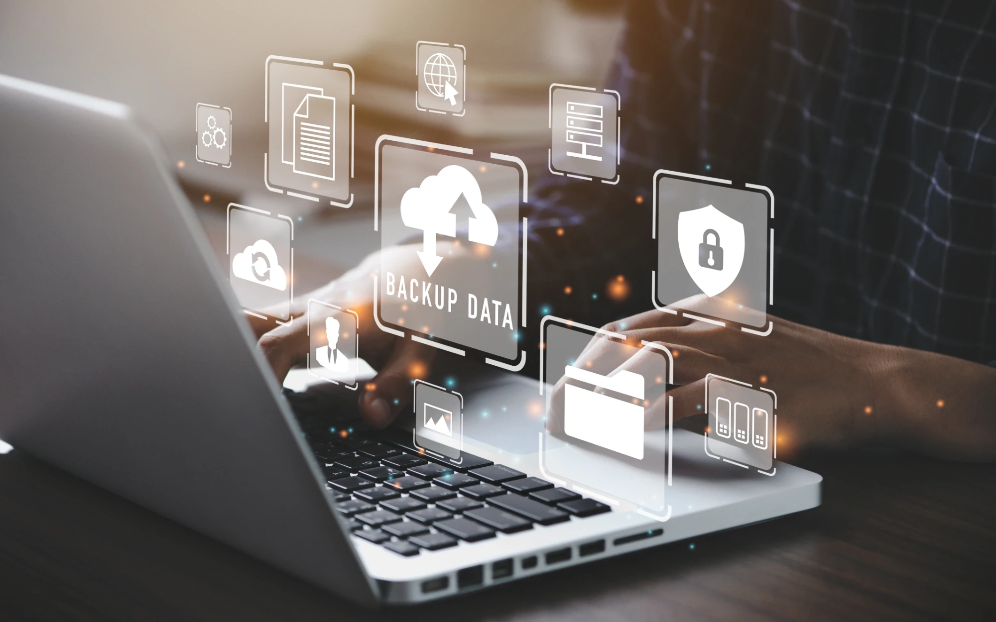 Laptop displaying BACKUP DATA with cloud storage icons